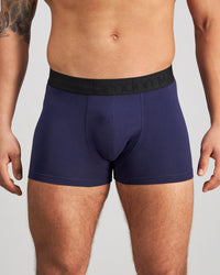 Model wears Everyday Essential Mens Trunk in PEACOAT. On body front view