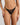 Model wears Midnight Magic Tanga in BLACK. On body front view
