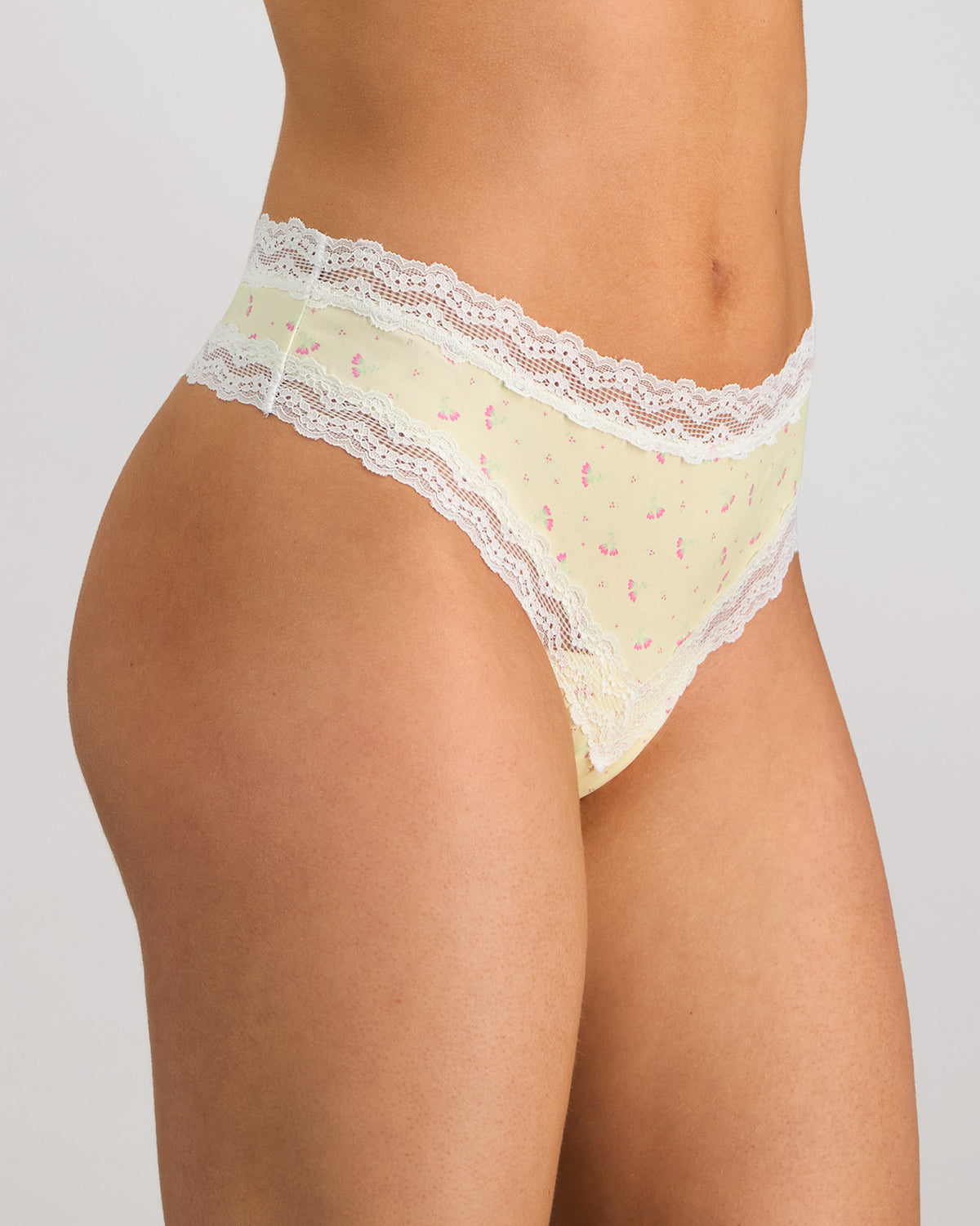 Model wears Daily Micro Thong in TRANSPARENT YELLOW. On body side view