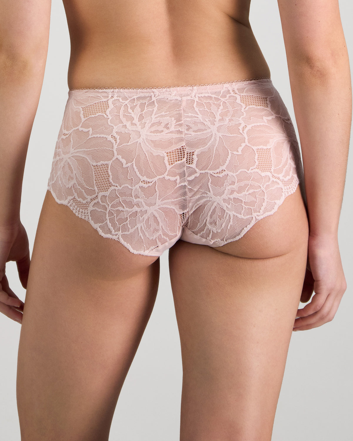 Model wears Midnight Express Full Brief in PALE LILAC. On body back view