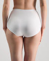 Model wears Freestyle Full Brief in WHITE. On body back view