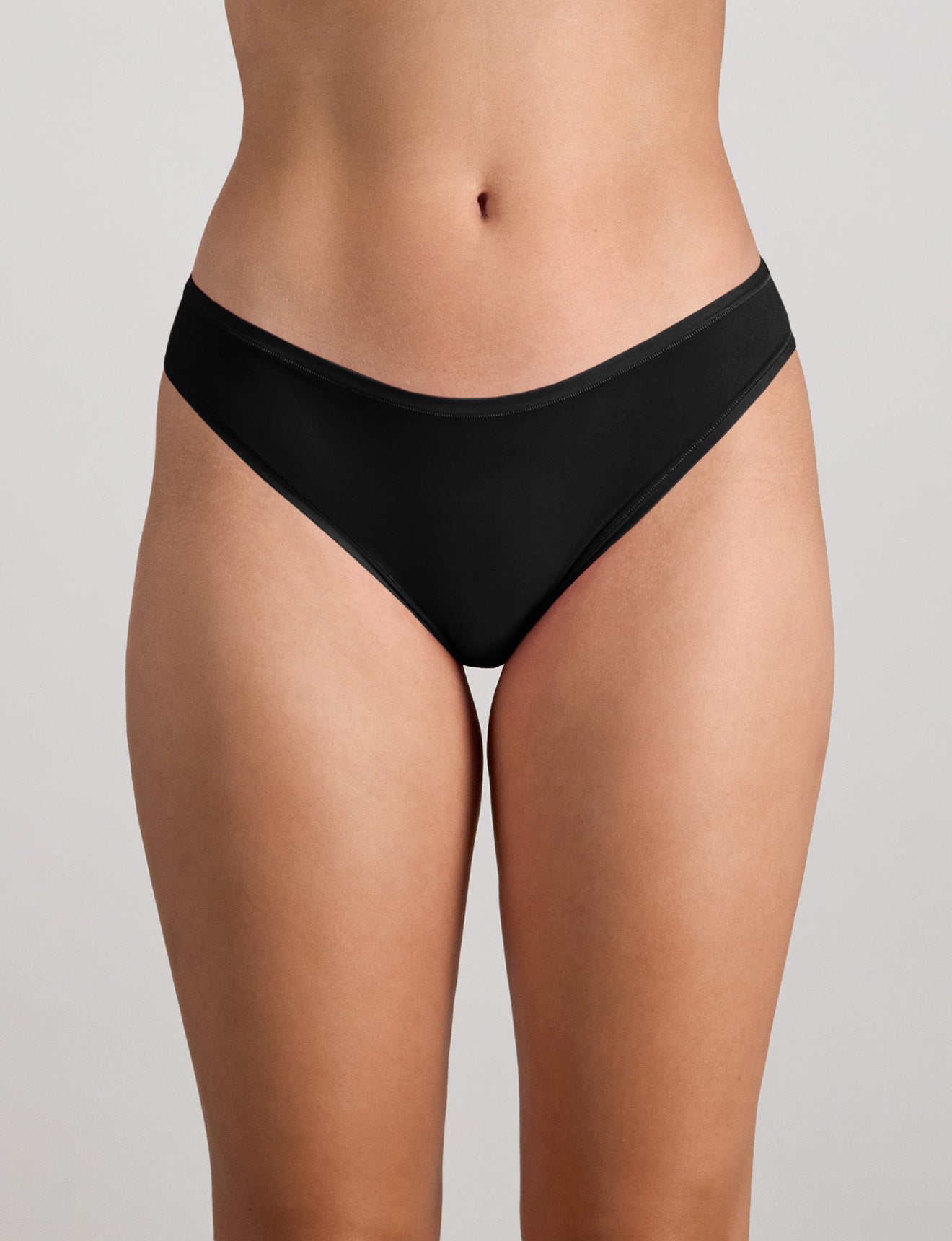 Model wears Extra-Ordinary Bikini in BLACK. On body front view