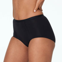 Model wears Body Cotton Full Brief in BLACK. On body side view