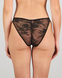 Model wears Scarlet Lover Tanga in BLACK. On body back view