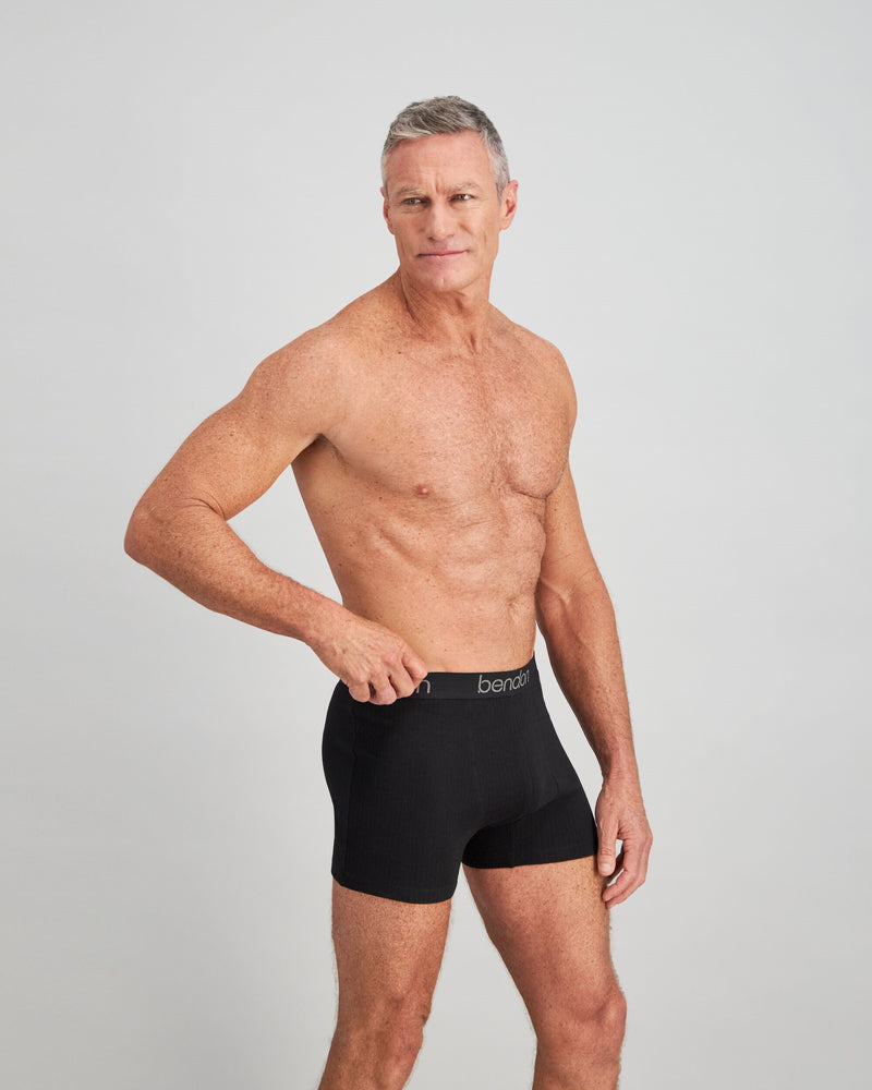 Model wears Cotton Texture Mens Trunk in BLACK. On body side view