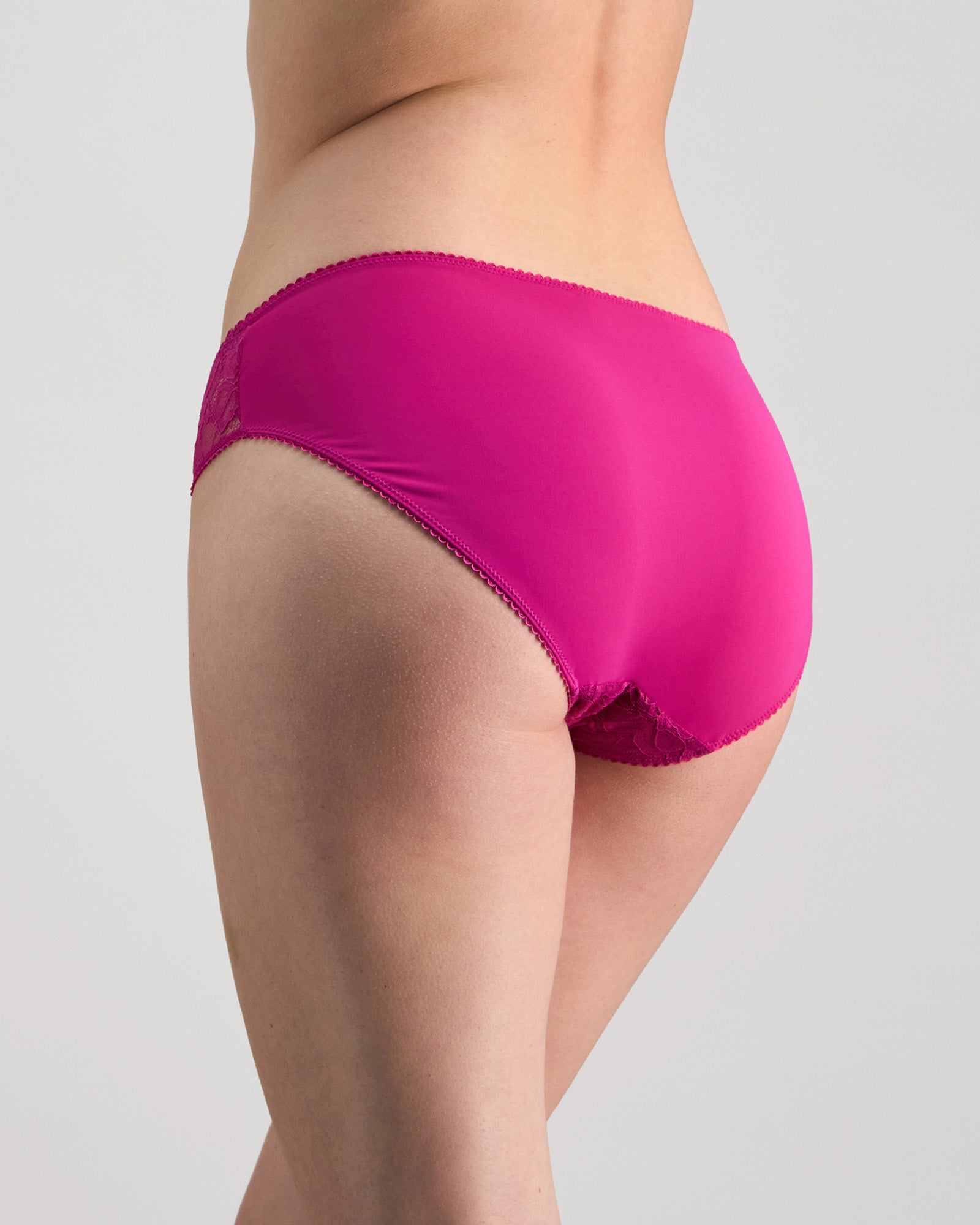 Model wears Lacey Bikini in FANTASY FUCHSIA. On body back view