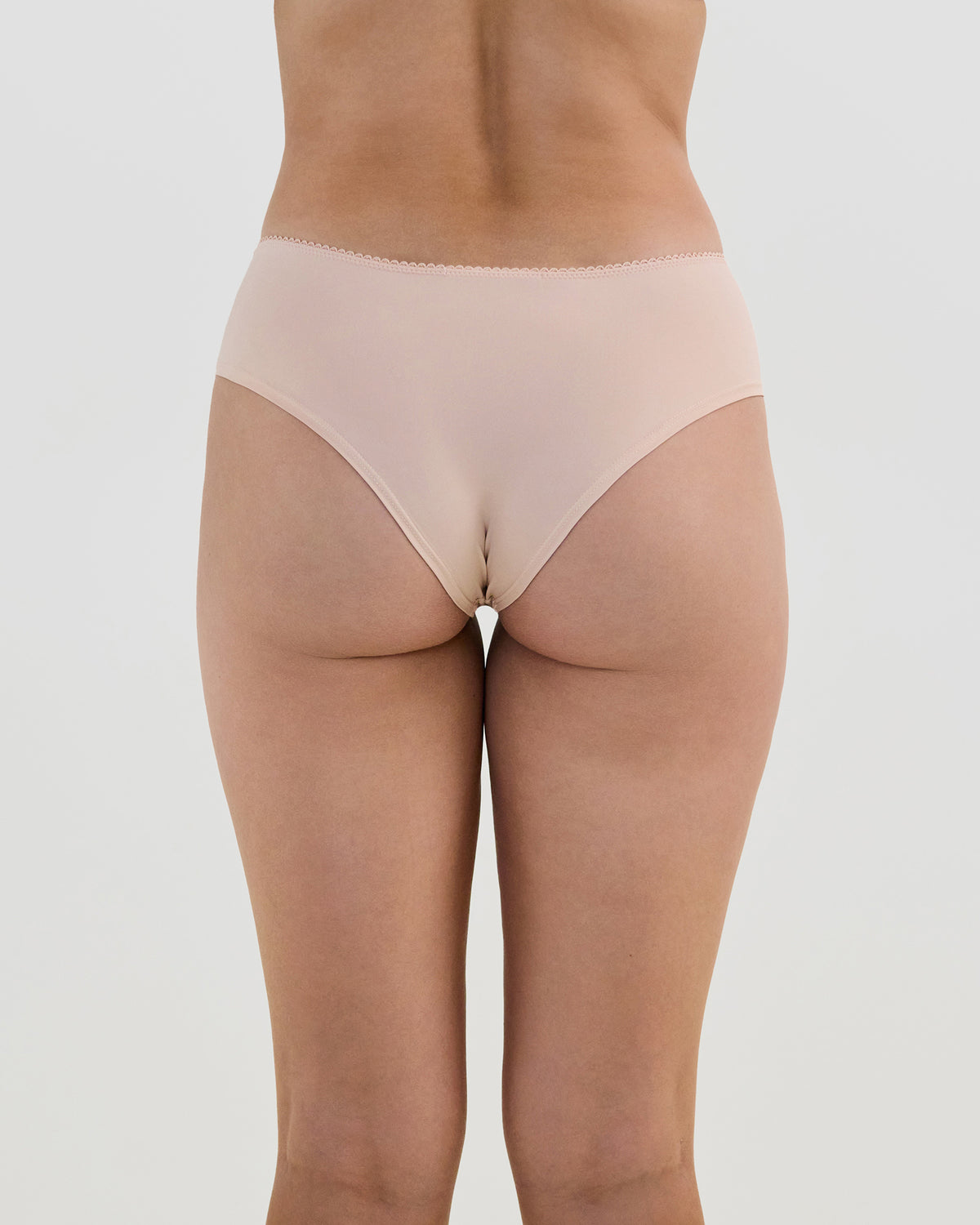 Model wears Lacey Brazilian in LATTE. On body back view