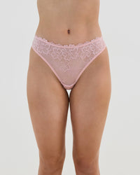 Model wears All Lacey Thong in SILVER PINK. On body front view