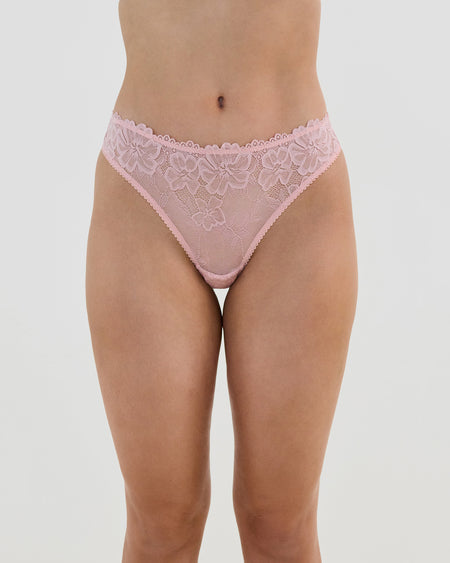 Model wears All Lacey Thong in SILVER PINK. On body front view