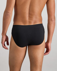 Model wears High Tech Cotton Mens Brief in BLACK. On body back view