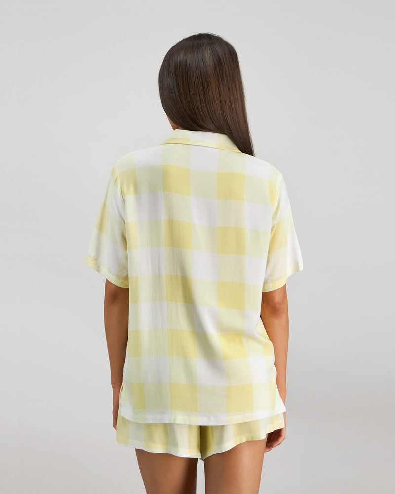 Model wears Dare To Dream Short PJ Set in LEMON MERINGUE. On body back view