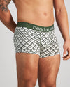 Model wears Retros Print Mens Trunk in ART DECO TILE PRINT. On body side view