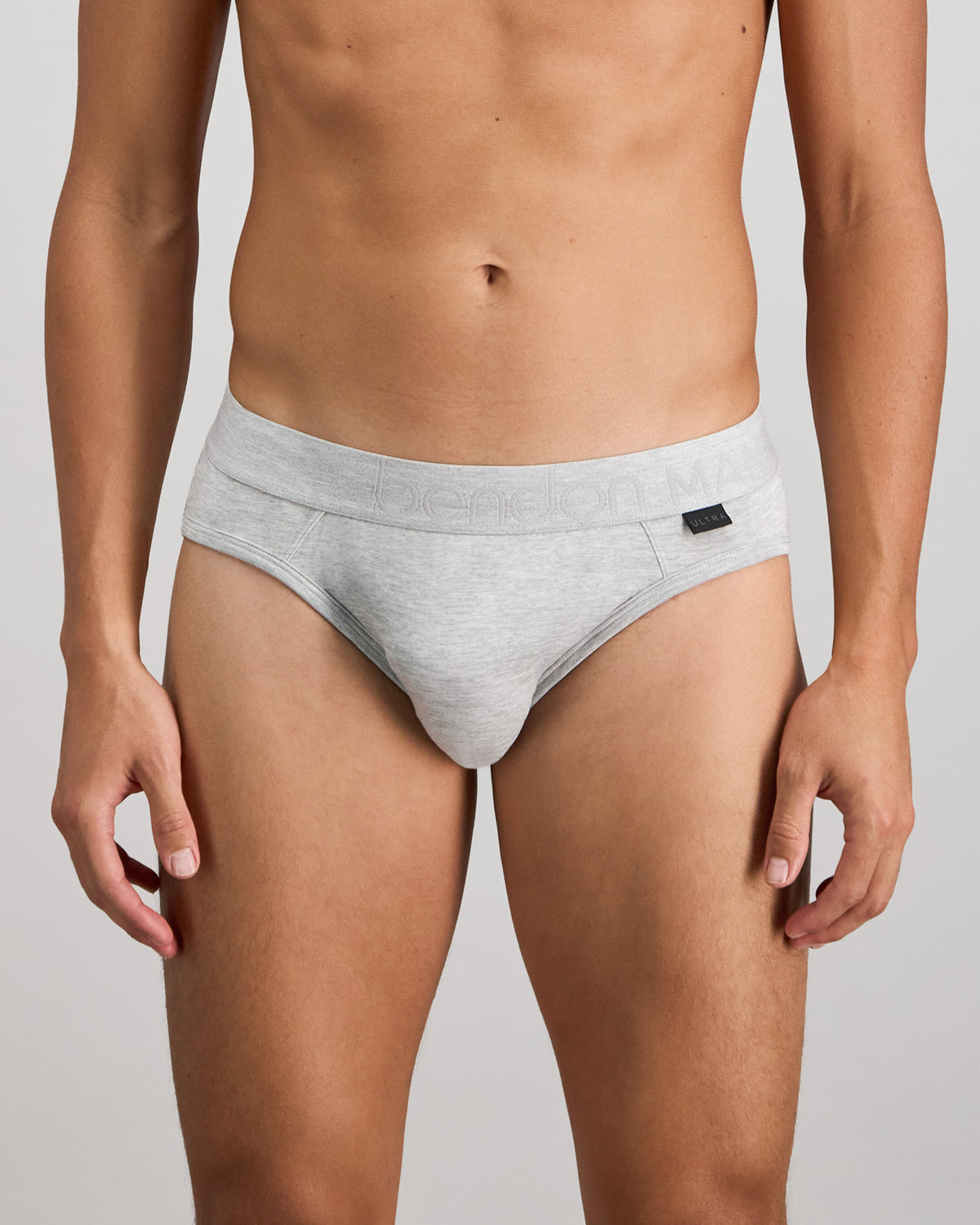 Model wears Bamboo Mens Brief in GREY MARLE. On body front view