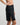 Model wears Understatement Slip in BLACK. On body side view