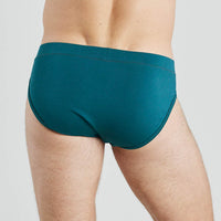 Model wears High Tech Cotton Mens Brief in DEEP TEAL. On body back view