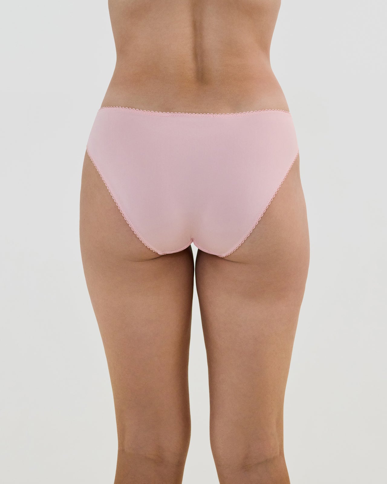 Model wears Lacey Bikini in SILVER PINK. On body back view
