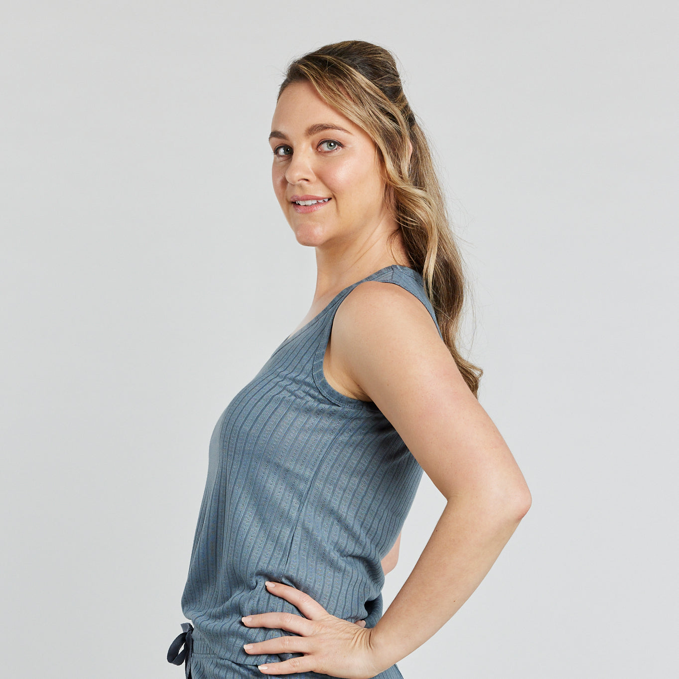 Model wears Charlene Singlet in EUCALYPTUS. On body side view