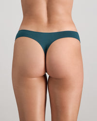Model wears Au Naturel Thong in MEDITERRANEA. On body back view