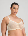 Model wears Delicate Lace Underwire Bra in IVORY/CREAM TAN. On body side view