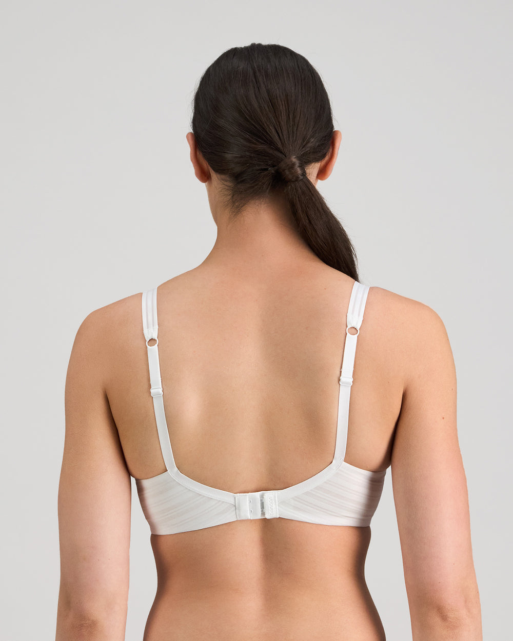 Model wears Rita Contour Bra in WHITE. On body back view