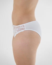 Model wears Embrace Bikini in WHITE. On body side view