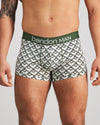 Model wears Retros Print Mens Trunk in ART DECO TILE PRINT. On body front view