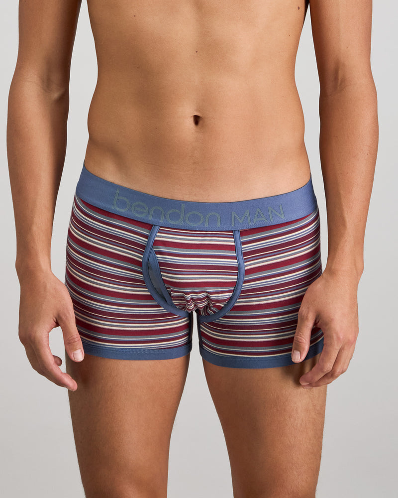 Model wears Bold Stripe Mens Trunk in INDIGO/FIG STRIPE. On body front view