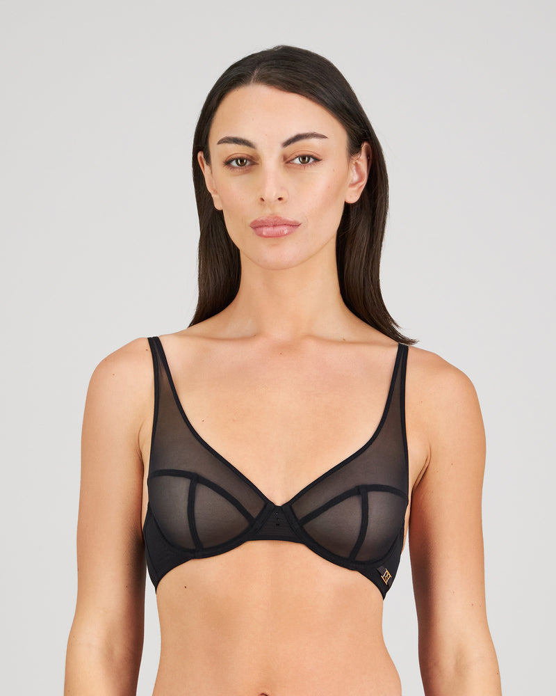 Model wears Sheer Impact Underwire Bra in BLACK. On body front view