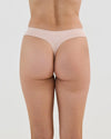 Model wears Seamless Soft Thong in LATTE. On body back view