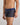Model wears Retros Print Mens Trunk in IRONCREST PRINT. On body side view