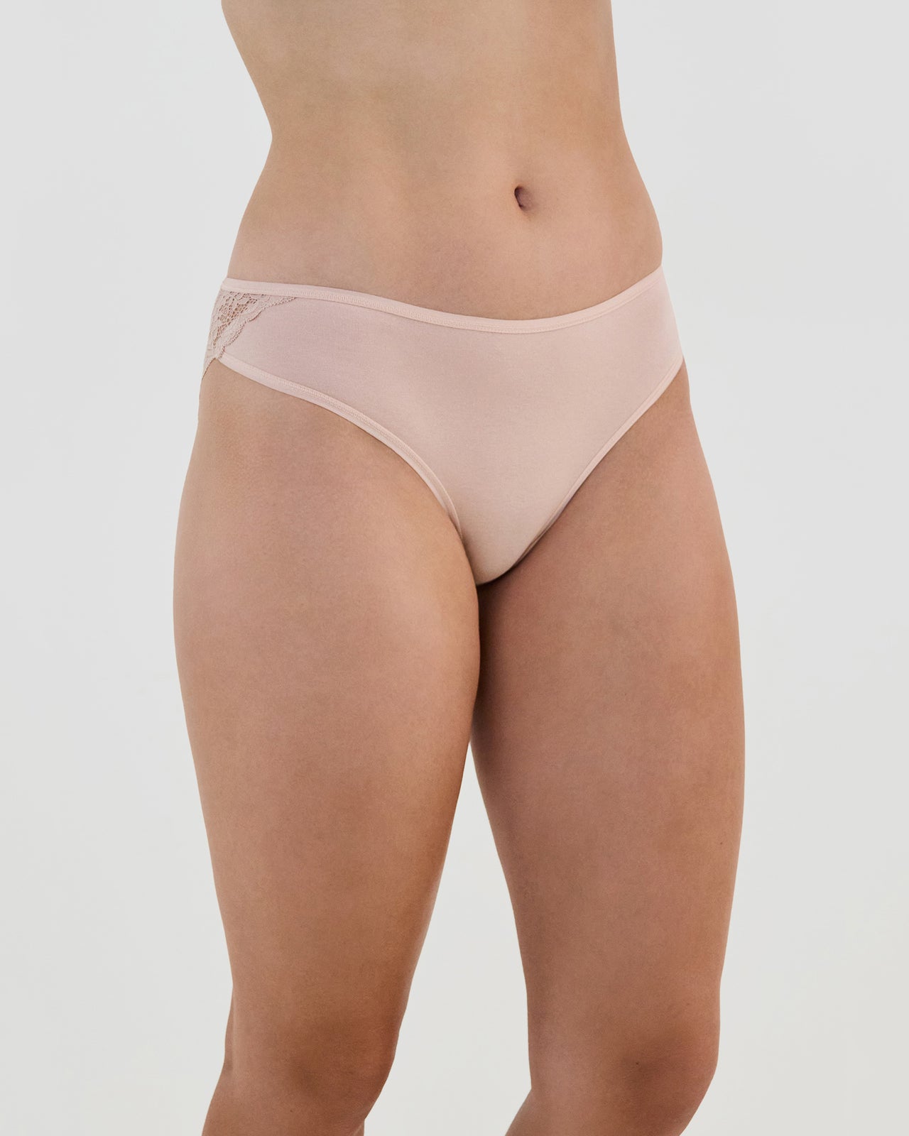 Model wears Cotton And Lace Bikini in LATTE. On body side view