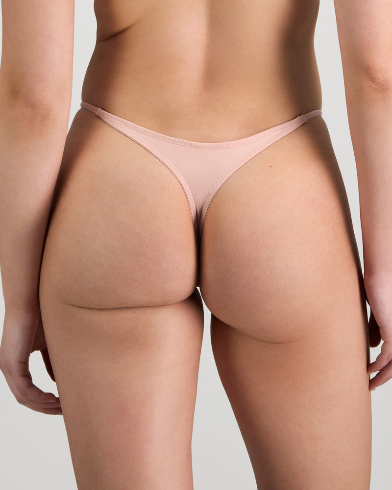 Model wears Aziza Thong in SILVER PINK/BLACK. On body back view