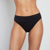 Model wears Seamless High Cut Brief in BLACK. On body front view