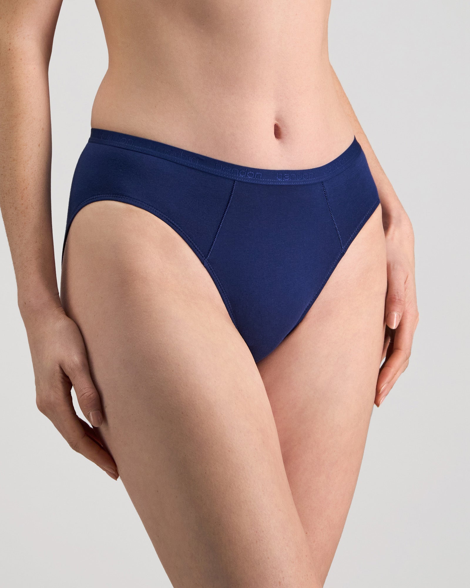 Model wears Body Cotton High Cut Brief in Medieval Blue. On body side view