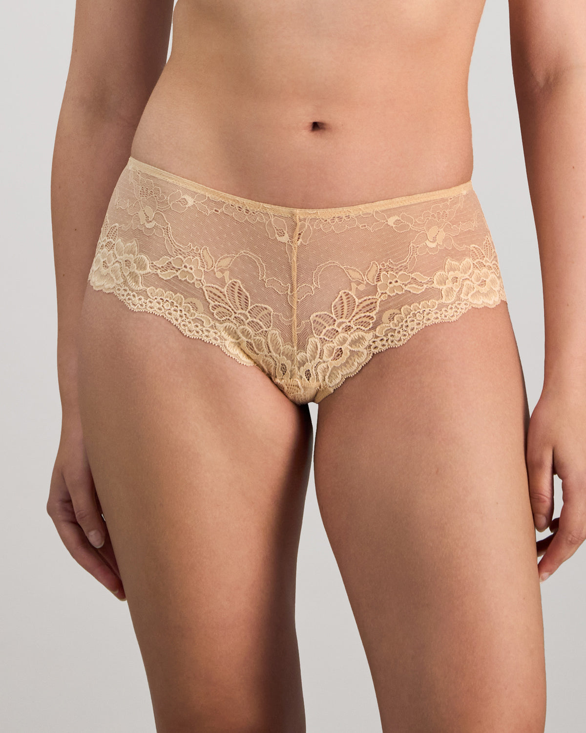 Model wears My Fit Lace Brazilian in FRAPPE. On body front view