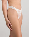 Model wears My Fit Lace Thong in WHITE. On body side view