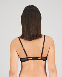 Model wears Sheer Impact Contour Bra in BLACK. On body back view
