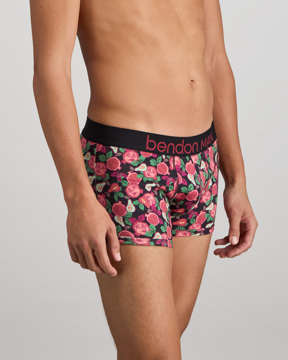 Model wears Retros Print Mens Trunk in SUMMER FRUITS PRINT. On body side view