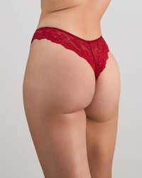 Model wears My Fit Lace Thong in JESTER RED. On body side view