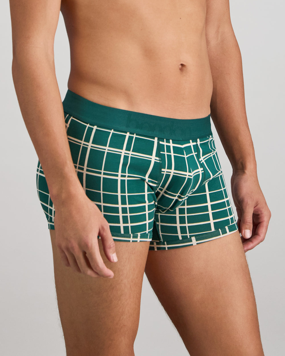Model wears Retros Print Mens Trunk in RAIN FOREST GRID PRINT. On body side view