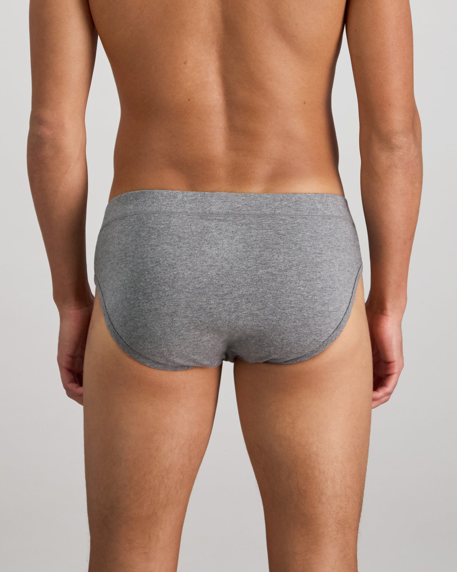 Model wears High Tech Cotton Mens Brief in GREY MARL. On body back view