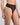 Model wears Sheer Essence Thong in BLACK. On body side view