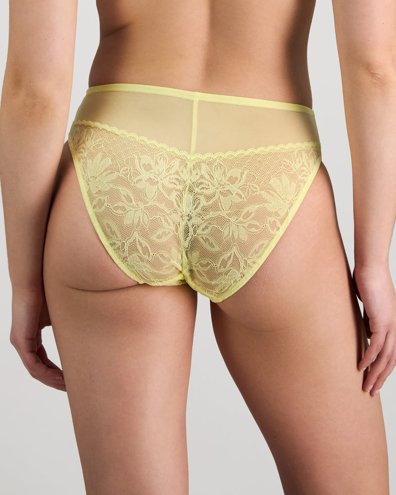 Model wears Elevate High Cut Brief in LEMON MERINGUE. On body back view
