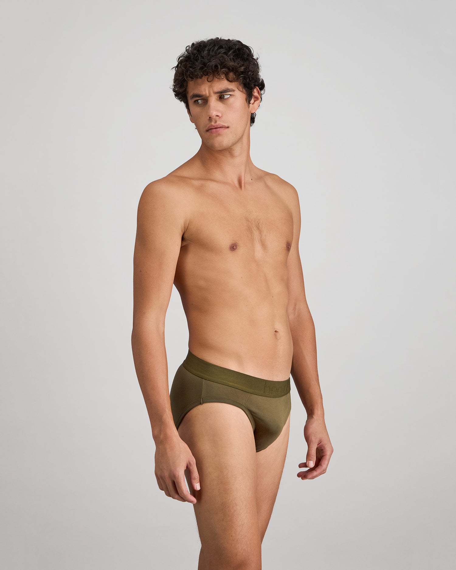 Model wears Bamboo Mens Brief in DARK OLIVE. On body side view