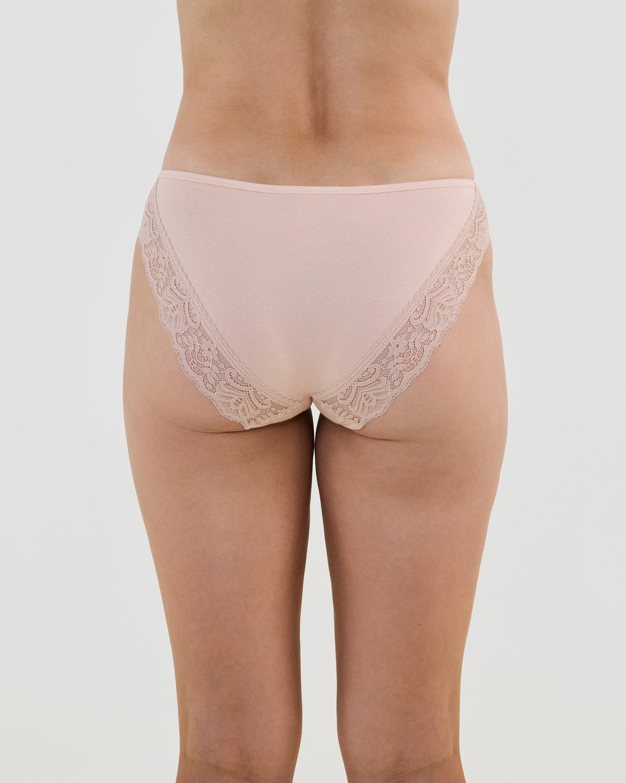 Model wears Cotton And Lace Bikini in LATTE. On body back view
