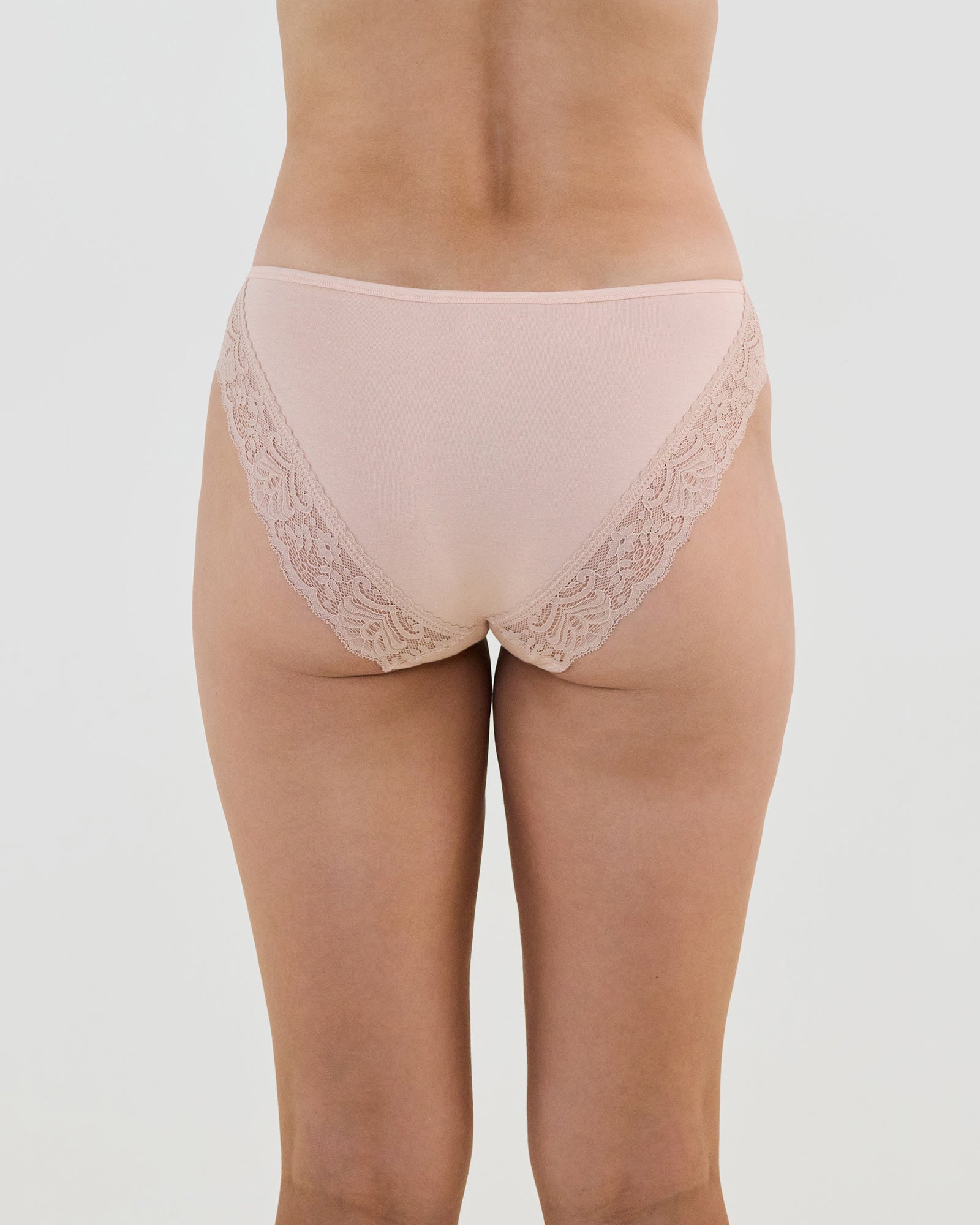 Model wears Cotton And Lace Bikini in LATTE. On body back view