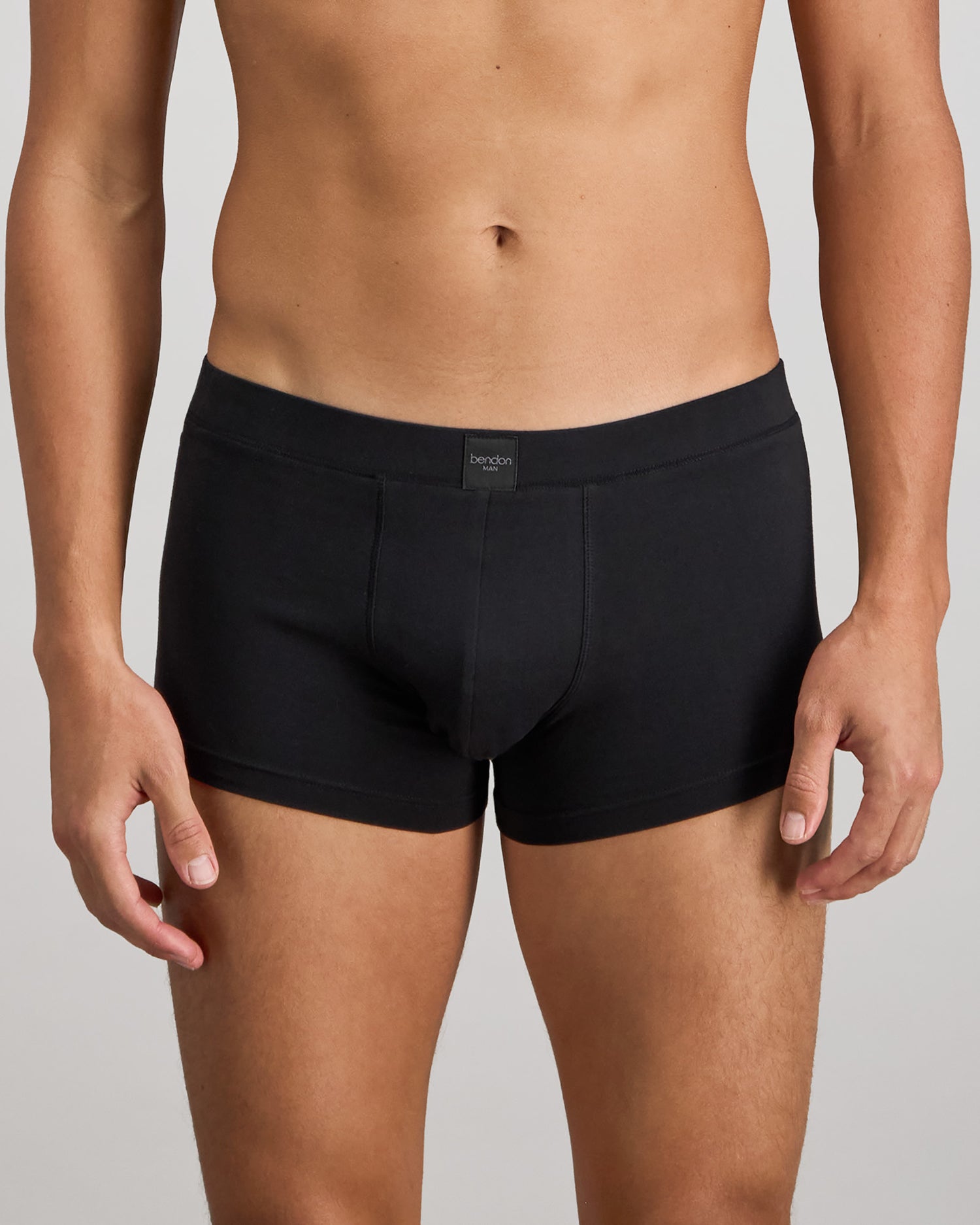Model wears High Tech Cotton Mens Trunk in BLACK. On body front view