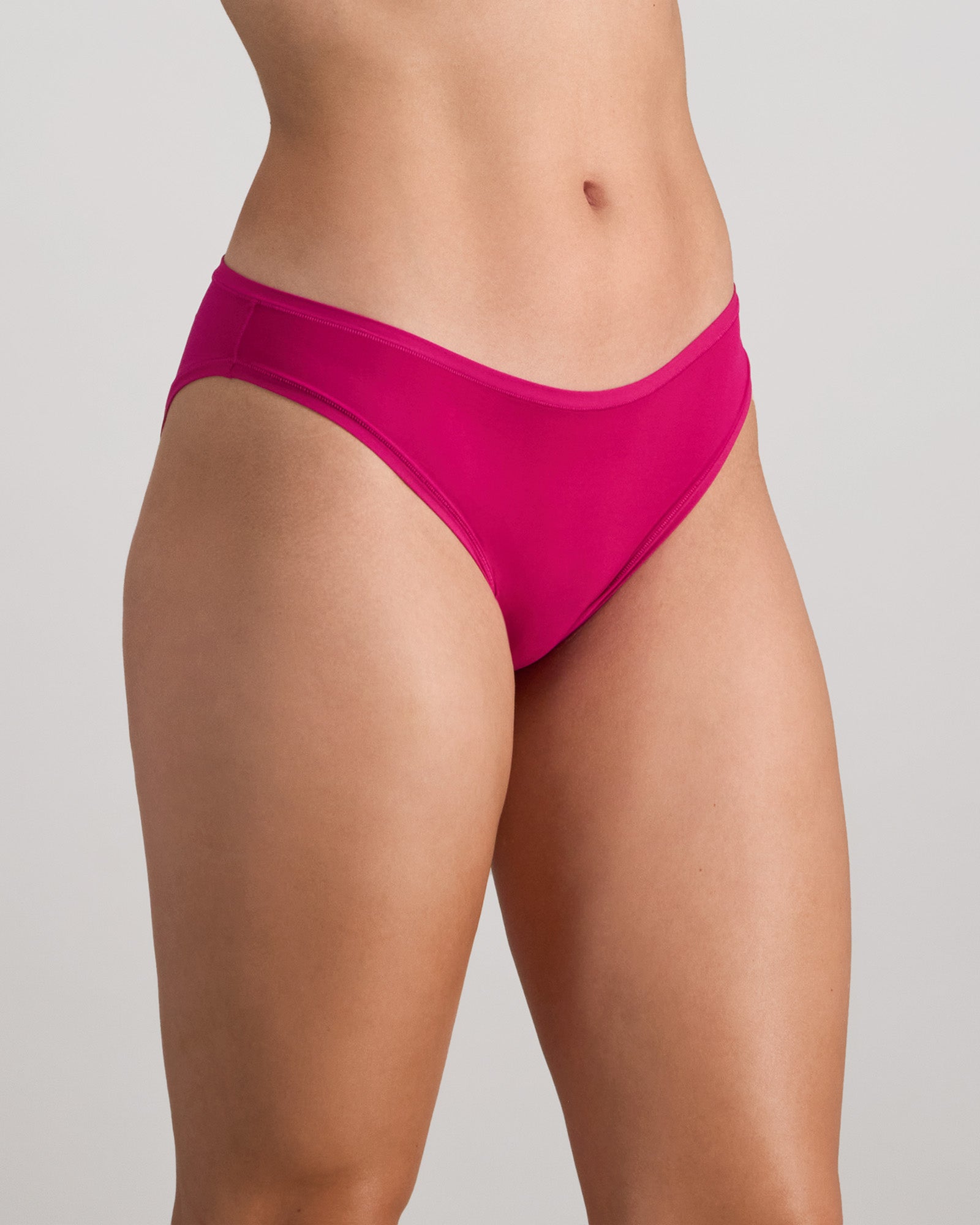 Model wears Extra-Ordinary Bikini in FANTASY FUCHSIA. On body side view