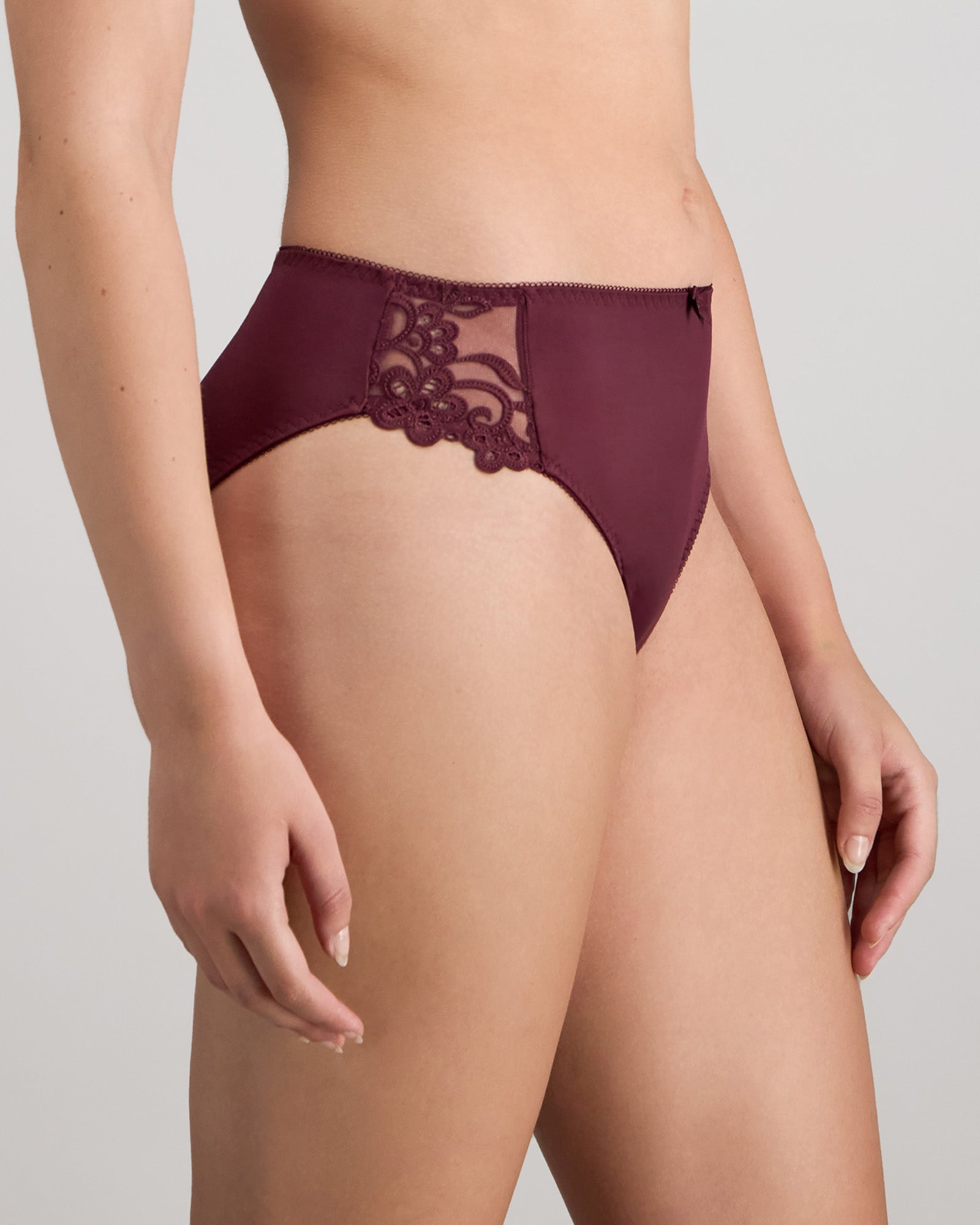 Model wears Coral High Cut Brief in FIG. On body side view