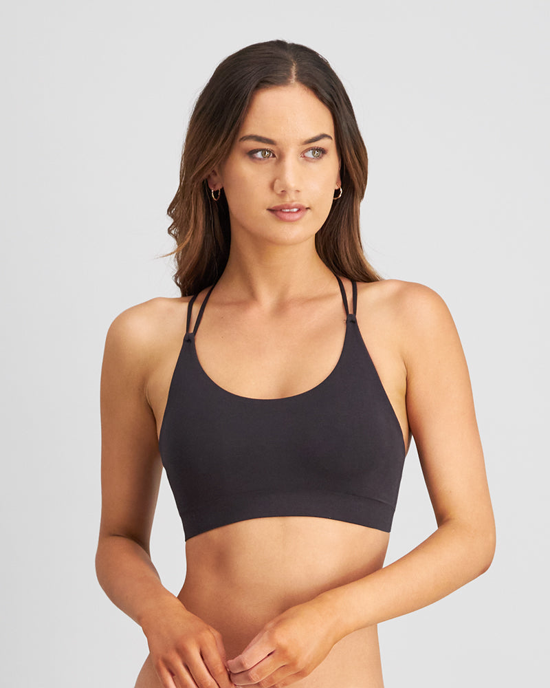 Model wears Exhale Crop Top in BLACK. On body front view